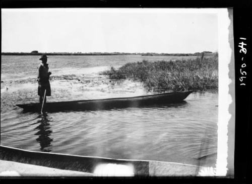 Man poling a boat along the Okavango River