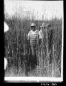 People standing in tall grass in the Okavango delta