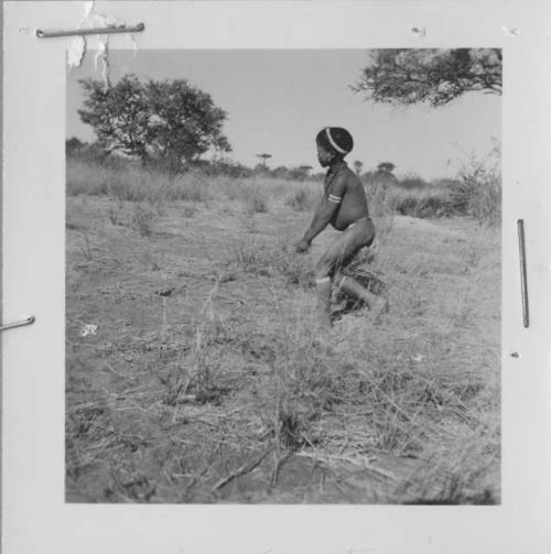 Boy pushing a toy car made from veldkos