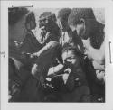 Group of women and children sitting closely together