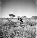 //Ao (son-in-law of "Old /Gaishay") chopping wood, distant view