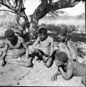 Three men sitting and looking at thrown oracle disks