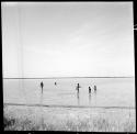 People walking in Gautscha Pan, full of water, distant view