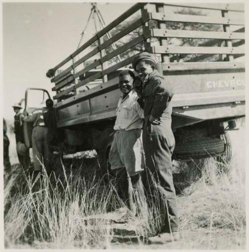 Philip Hameva and Heinrich Neumann standing next to an expedition truck