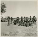 Men dancing, including "/Gao Medicine" whose hands are being held behind him by another man