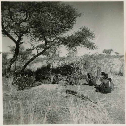 "Gao Helmet" making an assegai head in his werft, with members of his band sitting around him