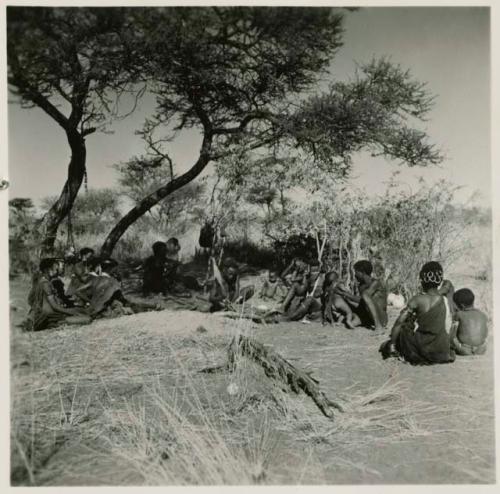 "Gao Helmet" making an assegai head in his werft, with members of his band sitting around him