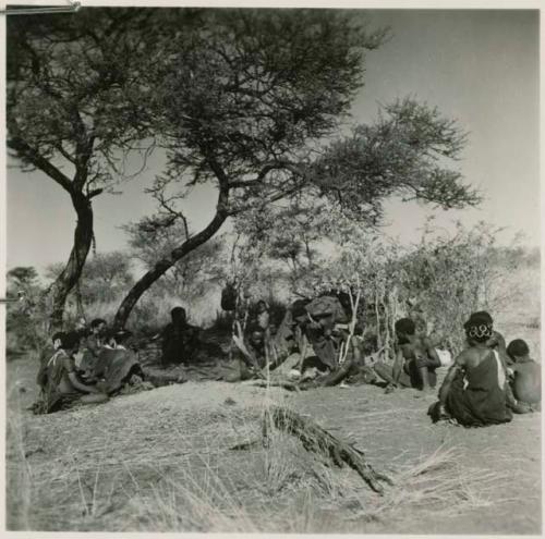 "Gao Helmet" making an assegai head in his werft, with members of his band sitting around him