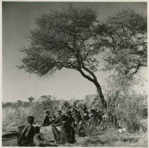 "Gao Helmet" making an assegai head in his werft, with members of his band sitting around him