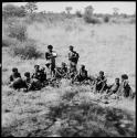 Group of women of /Ti!kay's group sitting, with the veldkos they have gathered in front of them