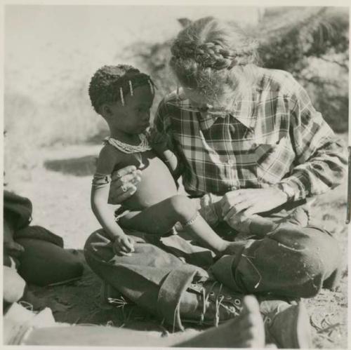 /Khoa (daughter of /Qui and /Naoka) sitting in Lorna Marshall's lap