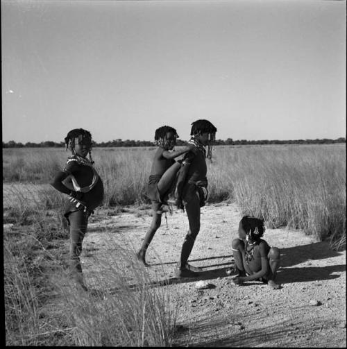 Girls playing the "piggy-back" game at the pan, including ≠Gisa (daughter of ≠Gao and Khwo//o-/Gasa), "Little N!ai" and ≠Nisa