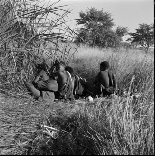 Group of people crouching at a waterhole