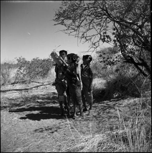 Girls standing in a little group, one of them playing a //guashi