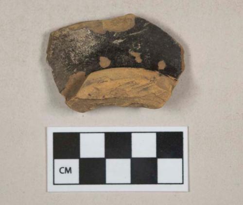 Dark brown lead glazed redware vessel base fragment