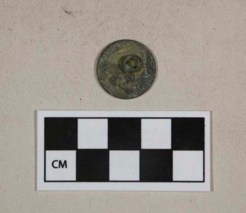 Metal alloy button, intact, indistinct engraving, gold washed, heavily corroded