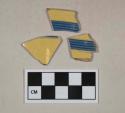 Yellow ware with blue banded decoration, likely mocha decorated, light buff paste