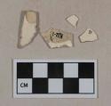 Whiteware vessel body fragments, white paste, one fragment with polychrome transfer decoration