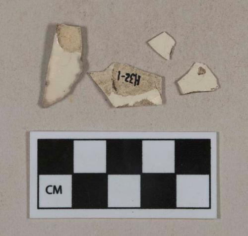Whiteware vessel body fragments, white paste, one fragment with polychrome transfer decoration