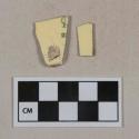 Light yellow lead glazed earthenware vessel body and base fragments, 1 fragment with partial black stamp, white paste
