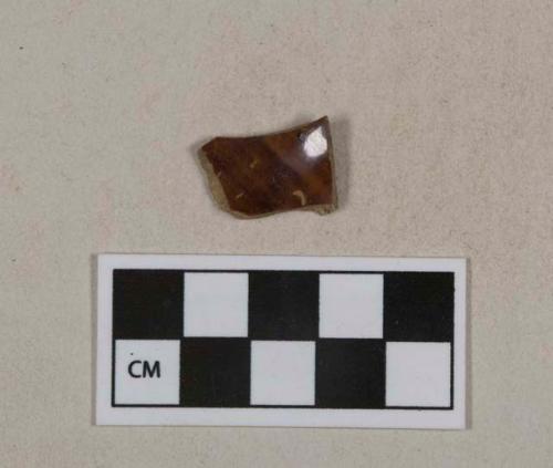 Brown mottled lead glazed earthenware vessel body fragment, buff paste, likely rockingham type