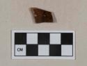 Mottled brown lead glaze redware vessel body fragment, likely rockingham type