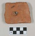 Red ceramic rooftile fragment with nail hole