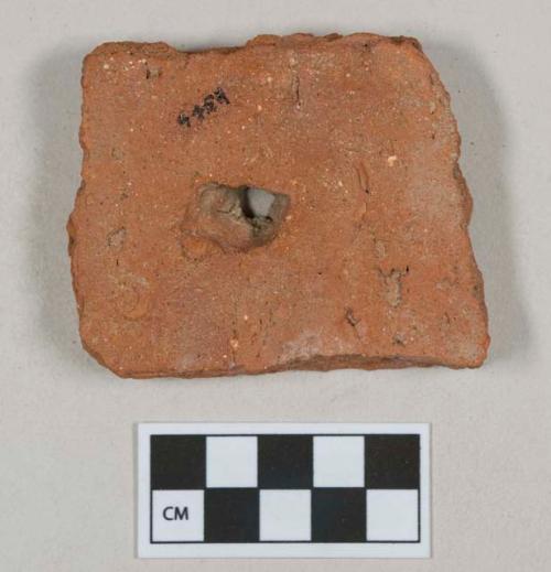 Red ceramic rooftile fragment with nail hole