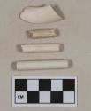White kaolin pipe bowl and stem fragments, bowl with partial stamp on exterior, stems with 4/64" bore diameter