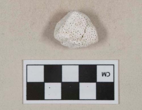 White coral fragment, heavily degraded, likely portion of mortar