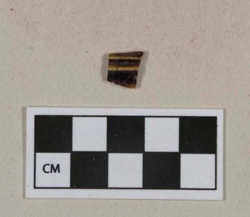 Dark brown mottled lead glazed earthenware vessel fragment, buff paste, likely Rockingham type