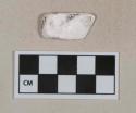 Unidentified white shell fragment, heavily degraded
