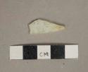 Colorless flat glass fragment, heavily weathered