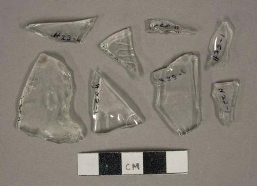 Colorless glass vessel fragments, 2 with embossed lettering