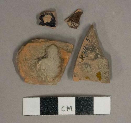 Brown lead glazed redware vessel body fragments, 1 fragment possibly burned or waster