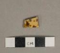 Brown on yellow sponge decorated lead glazed earthenware vessel body fragment, buff paste, likely clouded ware