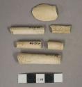 White undecorated kaolin pipe bowl and stem fragments, 1 bowl fragment, 1 stem fragment with 4/64" bore diameter, 4 stem fragments with 8/64" bore diameter