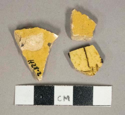 Yellow lead glazed earthenware vessel body fragments, brown slip-glazed decoration, buff paste, likely Staffordshire slipware