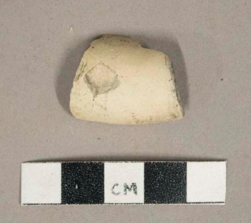 White undecorated kaolin pipe bowl fragment, burned interior