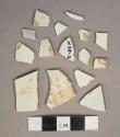 White undecorated pearlware vessel body and rim fragments, white paste