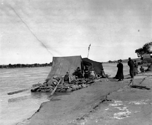 Boat with supplies/tents at shore