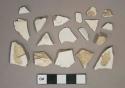 Undecorated whiteware vessel body and rim fragments, white paste