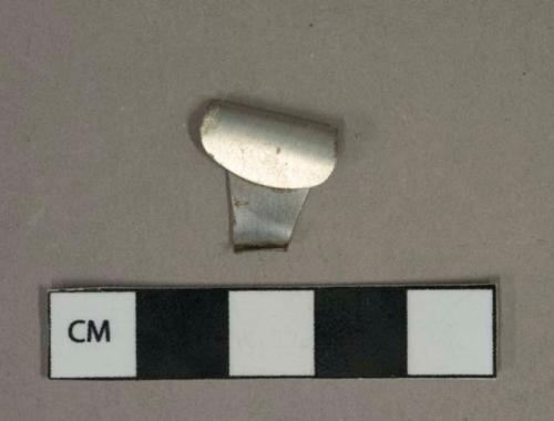 Metal alloy fragment, possibly tin can pull tab