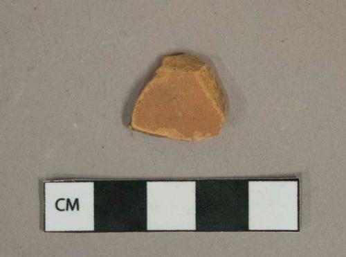 Undecorated, unglazed redware vessel body fragment, likely terracotta