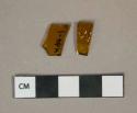 Amber glass vessel fragments, 1 with embossed decoration