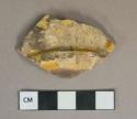 Yellow lead glazed earthenware vessel base fragment, buff paste, likely Staffordshire slipware