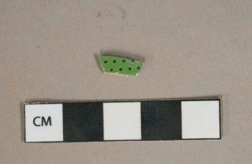 Lead glazed earthenware vessel body fragment, green with dots on exterior, cream interior, white paste