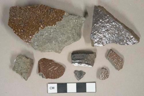 Dark brown salt glazed stoneware fragments, likely sewer pipe, dark gray paste with visible temper