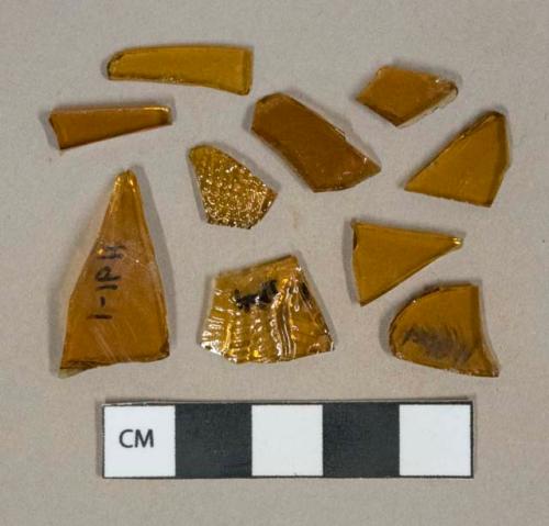 Amber glass vessel fragments, 2 fragments with molded decoration