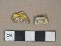 Gold and silver colored metal alloy fragments, likely wrappers